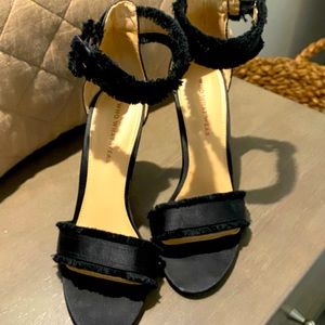 Black satin heels with frayed edges